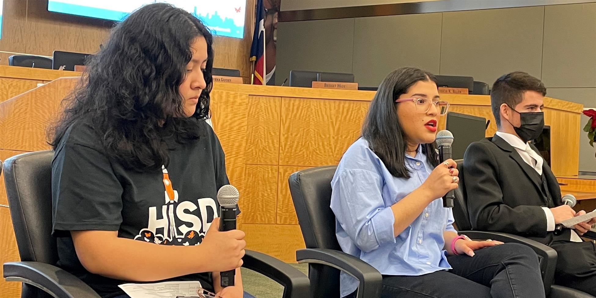  Three students answer questions at a Dream Summit panel discussion.